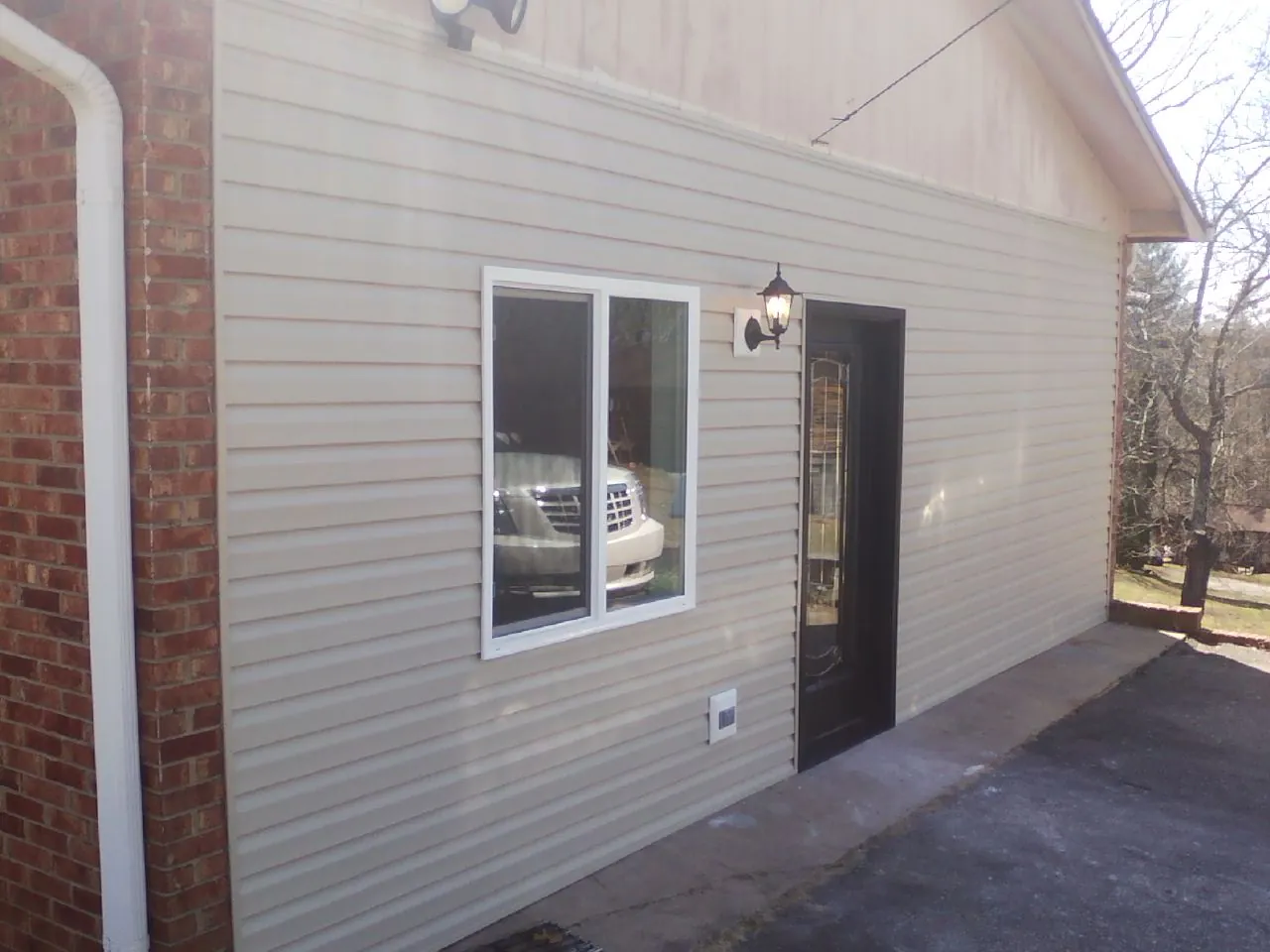 New vinyl siding and entry door on a room addition in Roswell